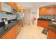 Modern kitchen with stainless steel appliances and wood cabinets at 231 Riverside Dr # 1106-1, Holly Hill, FL 32117