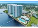Aerial view of waterfront highrise building with pool and dock at 231 Riverside Dr # 1106-1, Holly Hill, FL 32117