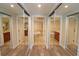 Bright bathroom entry with mirrored sliding doors and wood-look floors at 231 Riverside Dr # 1106-1, Holly Hill, FL 32117
