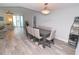 Bright dining room with modern light fixture and hardwood floors at 231 Riverside Dr # 1106-1, Holly Hill, FL 32117