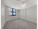 Spacious bedroom with large window and ceiling fan at 1415 Ocean Shore Blvd # 1112, Ormond Beach, FL 32176