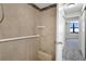 Updated bathroom with beige tile shower and built-in seat at 1415 Ocean Shore Blvd # 1112, Ormond Beach, FL 32176
