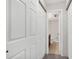 Hallway with white doors and carpet flooring, leading to bathroom at 1415 Ocean Shore Blvd # 1112, Ormond Beach, FL 32176