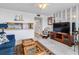 Living room with blue couch and kitchenette at 1433 N Atlantic Ave # 422, Daytona Beach, FL 32118