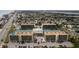 Aerial view of condo complex with tennis courts and pool at 1433 N Atlantic Ave # 422, Daytona Beach, FL 32118