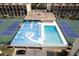 Community pool and tennis courts are seen from above at 1433 N Atlantic Ave # 422, Daytona Beach, FL 32118