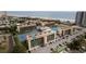 Aerial view of condo complex, highlighting tennis courts, pool, and parking at 1433 N Atlantic Ave # 422, Daytona Beach, FL 32118