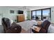Spacious living room with ocean view, comfy seating, and hardwood floors at 1239 Ocean Shore Blvd # 7E5, Ormond Beach, FL 32176