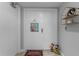 Bright condo entryway with decorative doormat and wall shelving at 1239 Ocean Shore Blvd # 7E5, Ormond Beach, FL 32176