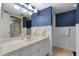 Clean condo bathroom with vanity, shower, and blue patterned walls at 1239 Ocean Shore Blvd # 7E5, Ormond Beach, FL 32176