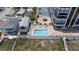 Overhead view of refreshing condo pool with surrounding patio furniture at 1239 Ocean Shore Blvd # 7E5, Ormond Beach, FL 32176