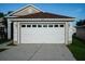 Two-story house with a brown roof, white garage door, and landscaped lawn at 2917 Wilshire Rd, Clermont, FL 34714