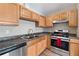 Kitchen features stainless steel appliances and dark countertops at 2917 Wilshire Rd, Clermont, FL 34714