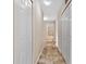 Clean hallway with tile floors and multiple doors leading to bedrooms and bathroom at 2917 Wilshire Rd, Clermont, FL 34714