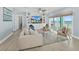 Living area featuring a large TV, built-in shelving, and access to balcony at 4711 S Atlantic Ave, Ponce Inlet, FL 32127