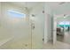 Large walk-in shower with pebble floor and built-in seat at 4711 S Atlantic Ave, Ponce Inlet, FL 32127