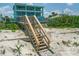 Wooden steps leading from the backyard to the sandy beach at 4711 S Atlantic Ave, Ponce Inlet, FL 32127