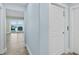 Hallway with light blue walls, wood-look floors, and ocean view at 4711 S Atlantic Ave, Ponce Inlet, FL 32127