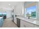 Modern kitchen with ocean view, white cabinets, and granite countertops at 4711 S Atlantic Ave, Ponce Inlet, FL 32127