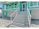 Exterior stairs leading to the front entrance of the home at 4711 S Atlantic Ave, Ponce Inlet, FL 32127