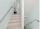 Modern light-toned stairs with metal railings leading to the upper level at 4711 S Atlantic Ave, Ponce Inlet, FL 32127