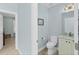 Powder room with single vanity and white cabinetry at 4711 S Atlantic Ave, Ponce Inlet, FL 32127