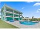 Large, freeform swimming pool with patio and lounge chairs at 4711 S Atlantic Ave, Ponce Inlet, FL 32127