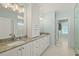 Elegant bathroom with double vanity, granite countertop, and large walk-in shower at 4711 S Atlantic Ave, Ponce Inlet, FL 32127