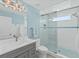 Bathroom with a walk-in shower, gray vanity, and white subway tile at 4711 S Atlantic Ave, Ponce Inlet, FL 32127