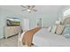Main bedroom with large TV, dresser, and access to bathroom at 4711 S Atlantic Ave, Ponce Inlet, FL 32127
