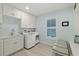 Convenient laundry room with washer, dryer, and built-in cabinets at 4711 S Atlantic Ave, Ponce Inlet, FL 32127