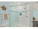 Bright, clean shower with glass enclosure and blue accent tiles at 4711 S Atlantic Ave, Ponce Inlet, FL 32127