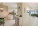 Kitchen features white cabinets, breakfast bar, and view into living area at 4575 S Atlantic Ave # 6310, Port Orange, FL 32127