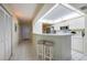Eat-in kitchen with breakfast bar and access to hallway at 4575 S Atlantic Ave # 6310, Port Orange, FL 32127