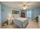 Bright bedroom with a striped bedspread and built-in wooden cabinet at 4575 S Atlantic Ave # 6310, Port Orange, FL 32127