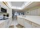Modern kitchen with white cabinetry, stainless steel appliances, and breakfast bar at 4575 S Atlantic Ave # 6310, Port Orange, FL 32127