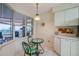Bright kitchen with white cabinets, stainless steel appliances, and breakfast nook at 4575 S Atlantic Ave # 6310, Port Orange, FL 32127
