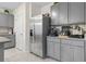 Stainless steel appliances and gray cabinetry in this well-equipped kitchen at 225 Sunset Point Dr, Ormond Beach, FL 32174