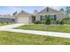 One-story home with neutral siding and a two-car garage at 225 Sunset Point Dr, Ormond Beach, FL 32174
