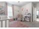 Charming Bedroom features a crib, armchair, and plenty of storage at 225 Sunset Point Dr, Ormond Beach, FL 32174