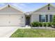 One-story home with a neutral facade and landscaping at 225 Sunset Point Dr, Ormond Beach, FL 32174