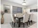Elegant dining room featuring a dark wood table and six upholstered chairs at 225 Sunset Point Dr, Ormond Beach, FL 32174