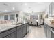 Open kitchen design with island, granite counters, and view of dining area at 225 Sunset Point Dr, Ormond Beach, FL 32174