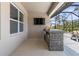 Covered patio with outdoor kitchen and screened enclosure at 225 Sunset Point Dr, Ormond Beach, FL 32174
