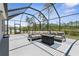 Relaxing screened lanai with seating and fire pit, perfect for outdoor entertaining at 225 Sunset Point Dr, Ormond Beach, FL 32174