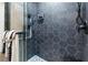 Walk-in shower with hexagon tile and built-in shelves at 225 Sunset Point Dr, Ormond Beach, FL 32174