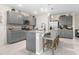 Modern kitchen with gray cabinets, granite countertops, and stainless steel appliances at 225 Sunset Point Dr, Ormond Beach, FL 32174