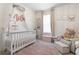Bright Bedroom with a crib, plush chair, and soft rug at 225 Sunset Point Dr, Ormond Beach, FL 32174