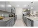 Modern kitchen with gray cabinets, granite countertops, and island at 225 Sunset Point Dr, Ormond Beach, FL 32174