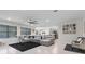 Spacious living room with gray sectional sofa and large windows at 225 Sunset Point Dr, Ormond Beach, FL 32174